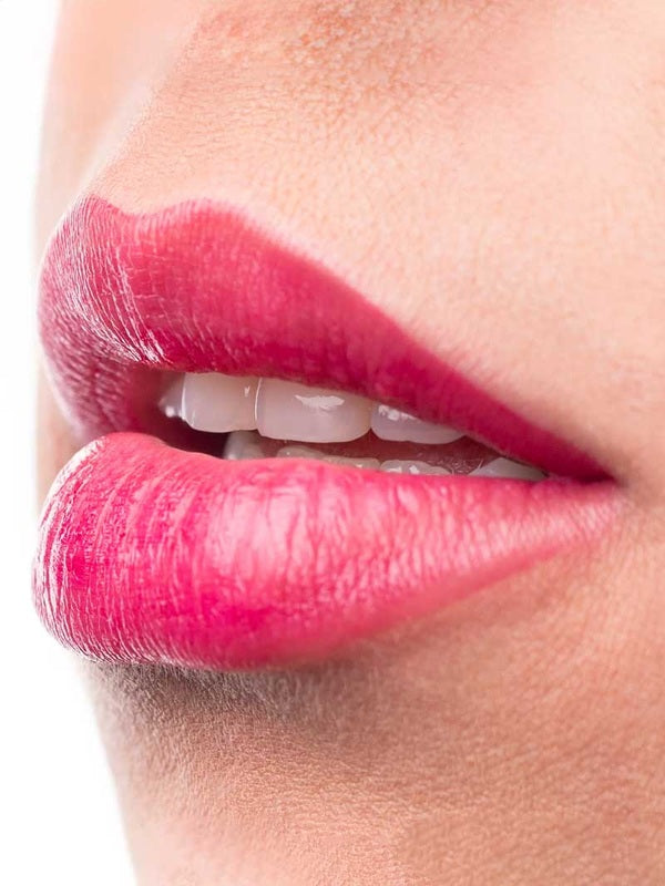 Close-up of glossy bright cherry lips wearing 100% Pure Cherry Lip & Cheek Stain.