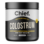 Chief Colostrum powder in a black cylindrical tub with a broad black lid, a silver upper label and large cream lettering.
