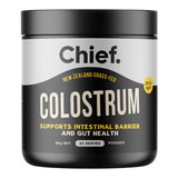 Chief Colostrum powder in a black cylindrical tub with a broad black lid, a silver upper label and large cream lettering.