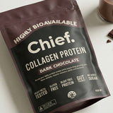 CHIEF Dark Chocolate Collagen Protein styled with chocolate and a drink