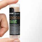Hand holding Hurraw! Choco & Mint Lip Balm 4.8g