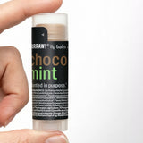Hand holding Hurraw! Choco & Mint Lip Balm 4.8g