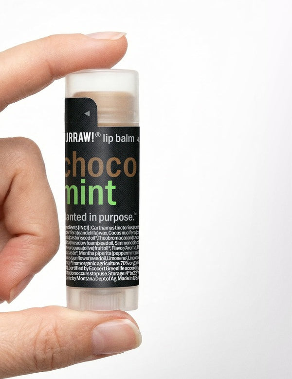 Hand holding Hurraw! Choco & Mint Lip Balm 4.8g