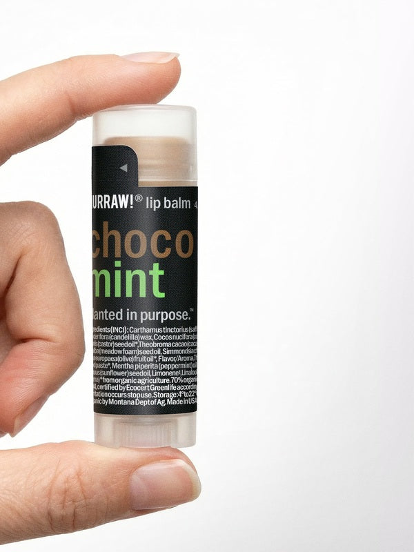 Hand holding Hurraw! Choco & Mint Lip Balm 4.8g