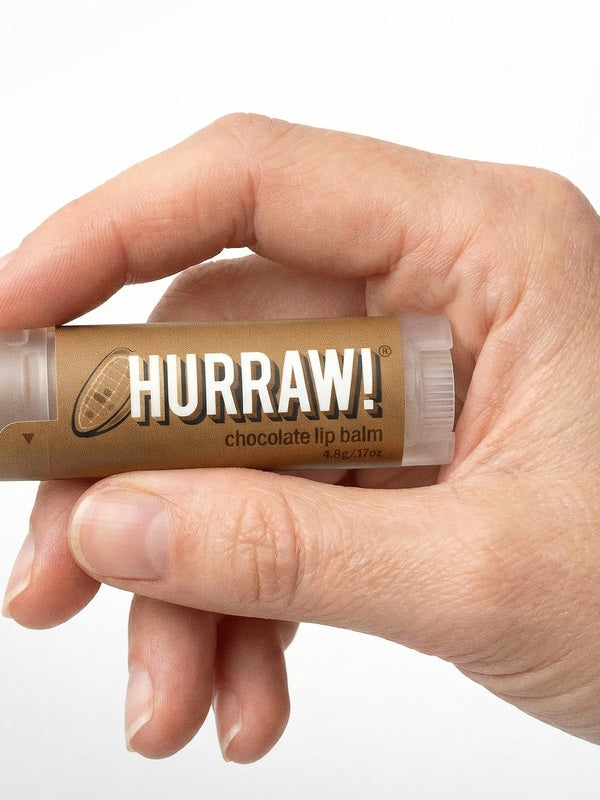 Hand holding Hurraw! Organic Lip Balm - Chocolate 4.8g