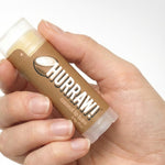 Hand holding Hurraw! Organic Lip Balm - Coconut 4.8g