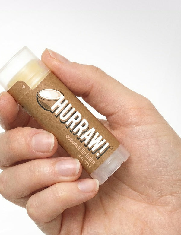 Hand holding Hurraw! Organic Lip Balm - Coconut 4.8g