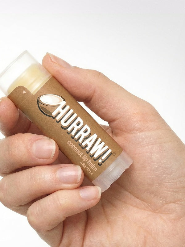 Hand holding Hurraw! Organic Lip Balm - Coconut 4.8g