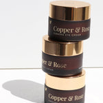 Stacked jars of Vanessa Megan Copper and Rose Firming Eye Cream