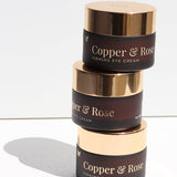 Stacked jars of Vanessa Megan Copper and Rose Firming Eye Cream