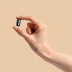 Hand holding a Herbs of Gold Magnesium Night tablet