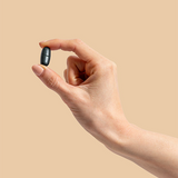 Hand holding a Herbs of Gold Magnesium Night tablet