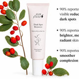 A pale pink 100% Pure Dark Spot Remover tube stands beside green leaves and red berries. Partly cropped text lists three 90% study results about dark spots, brighter skin and a smoother complexion, with a six-week-study footnote.