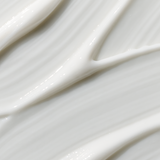 Extreme close-up of glossy white cream swept diagonally into smooth folds and narrow raised ridges.