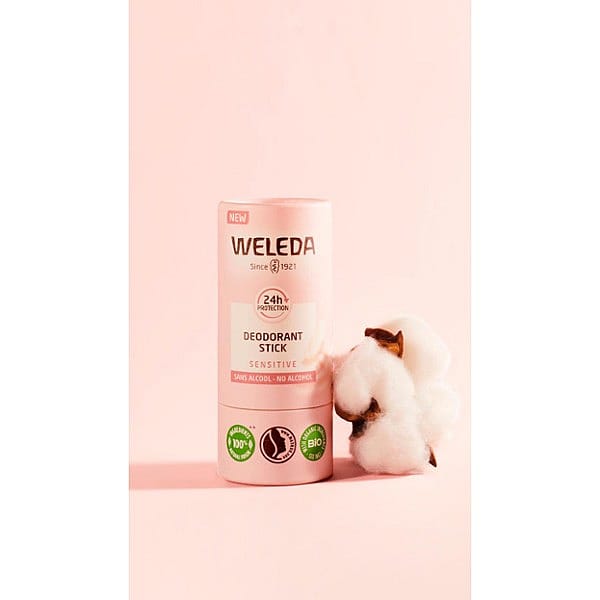 Deodorant Stick Sensitive, next to almond blossom, against pink background.