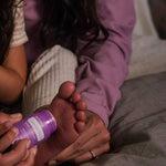 Parent applying doTERRA Lavender Peace Stick to a child’s foot