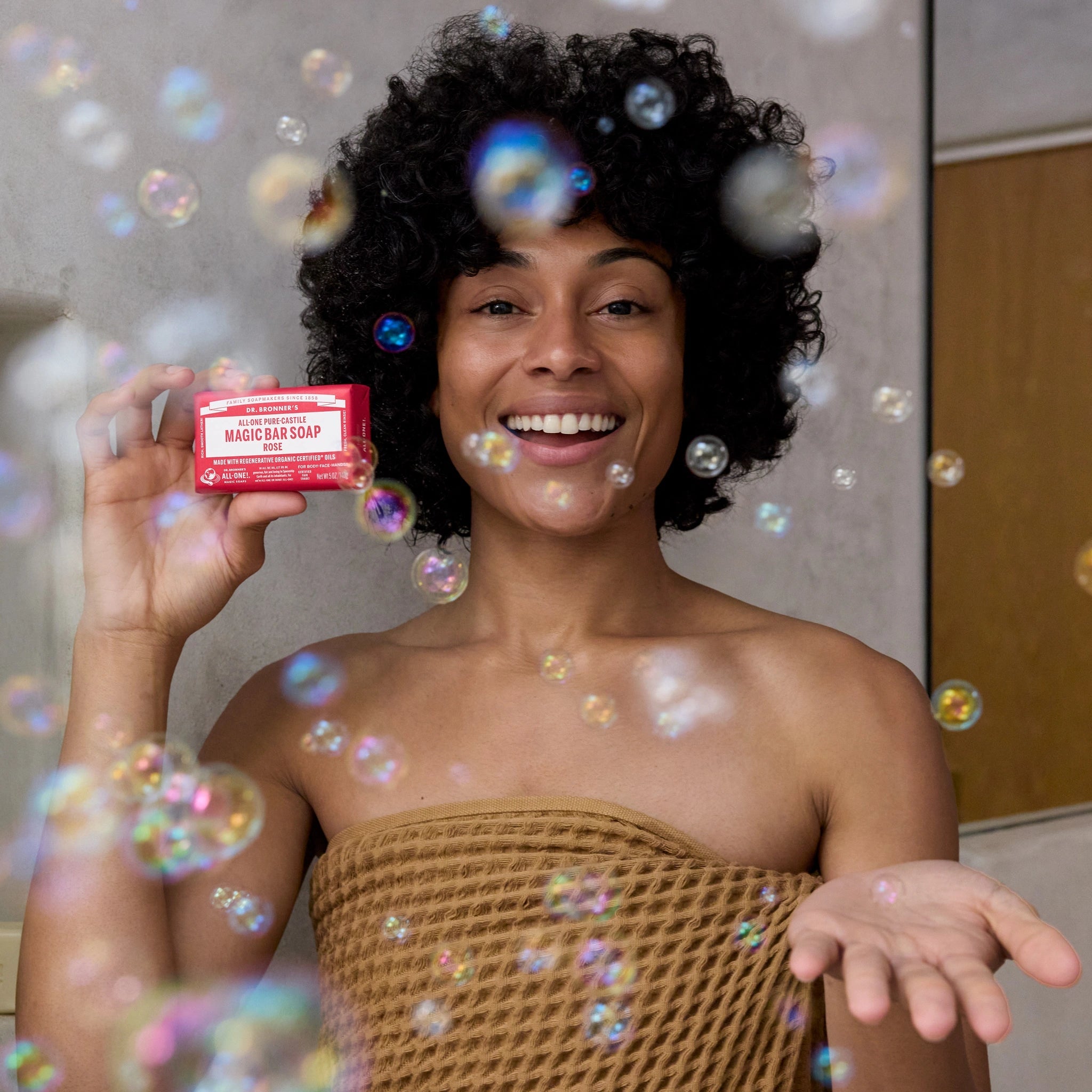 Person enjoying Dr. Bronner's Rose Magic Bar Soap