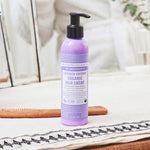 Dr. Bronner's Lavender and Coconut Leave In Conditioner bottle displayed in a bright bathroom setting.