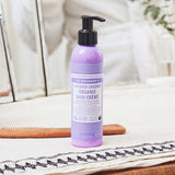Dr. Bronner's Lavender and Coconut Leave In Conditioner bottle displayed in a bright bathroom setting.