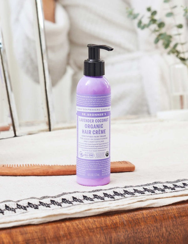 Dr. Bronner's Lavender and Coconut Leave In Conditioner bottle displayed in a bright bathroom setting.