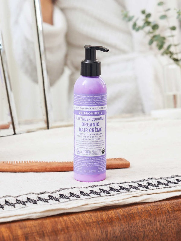 Dr. Bronner's Lavender and Coconut Leave In Conditioner bottle displayed in a bright bathroom setting.