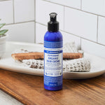 Dr. Bronner's Peppermint Organic Hair Creme in a bathroom setting