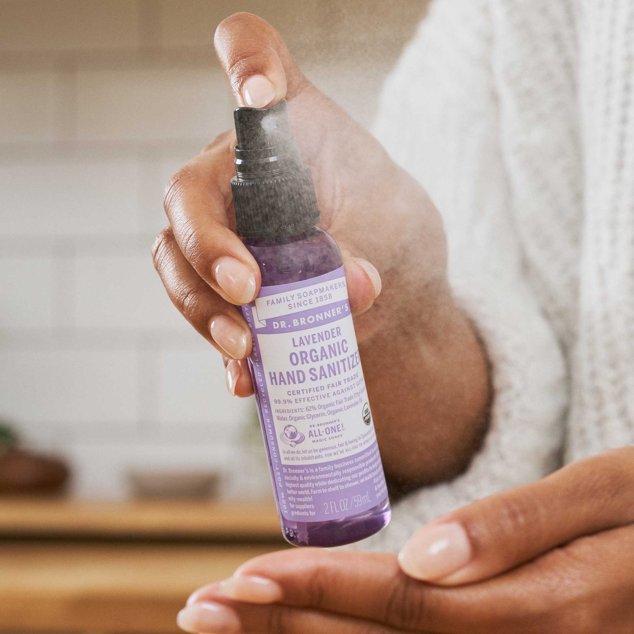 Person using Dr. Bronner's Lavender Organic Hand Sanitizer