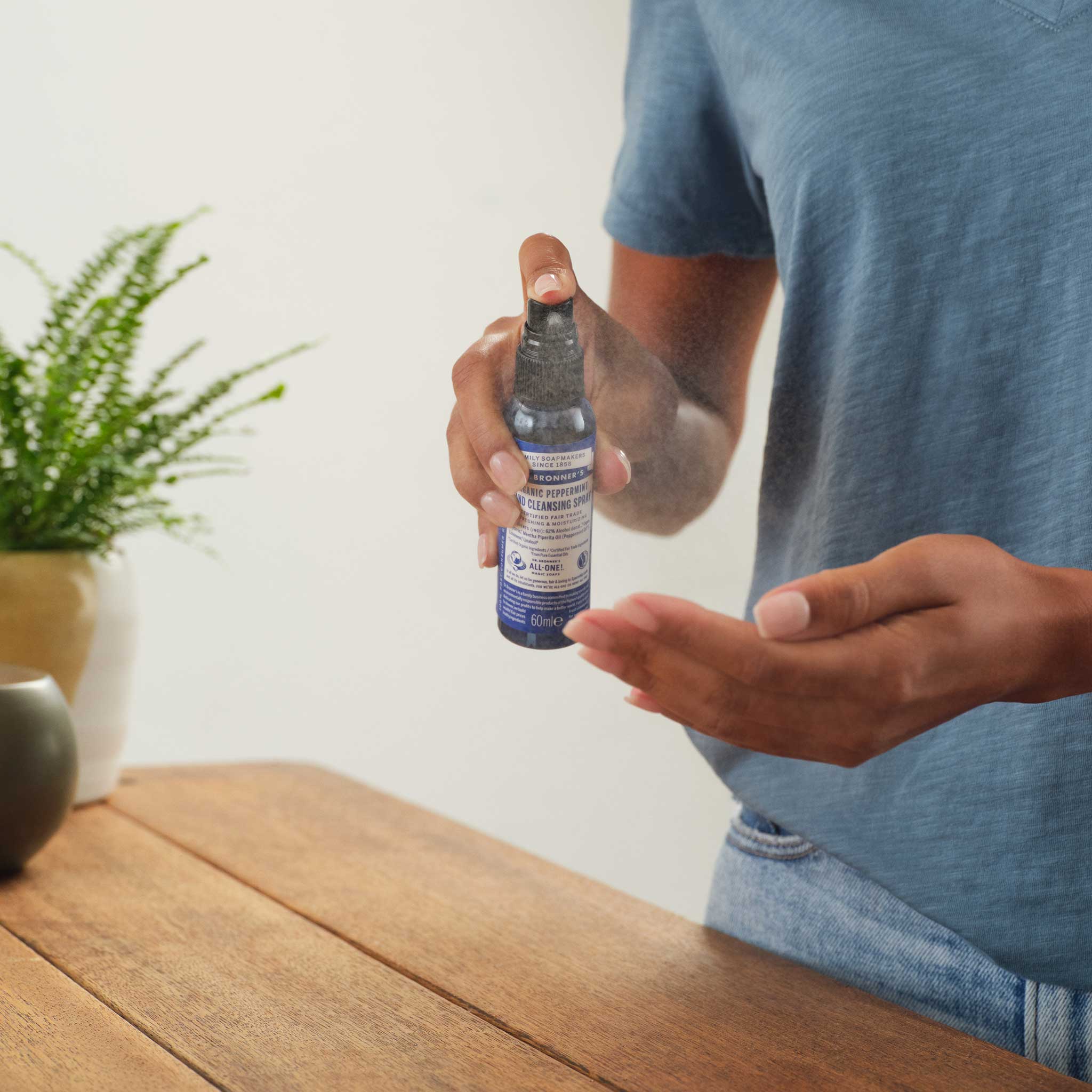 Person using Dr. Bronner's Peppermint Organic Hand Sanitizer