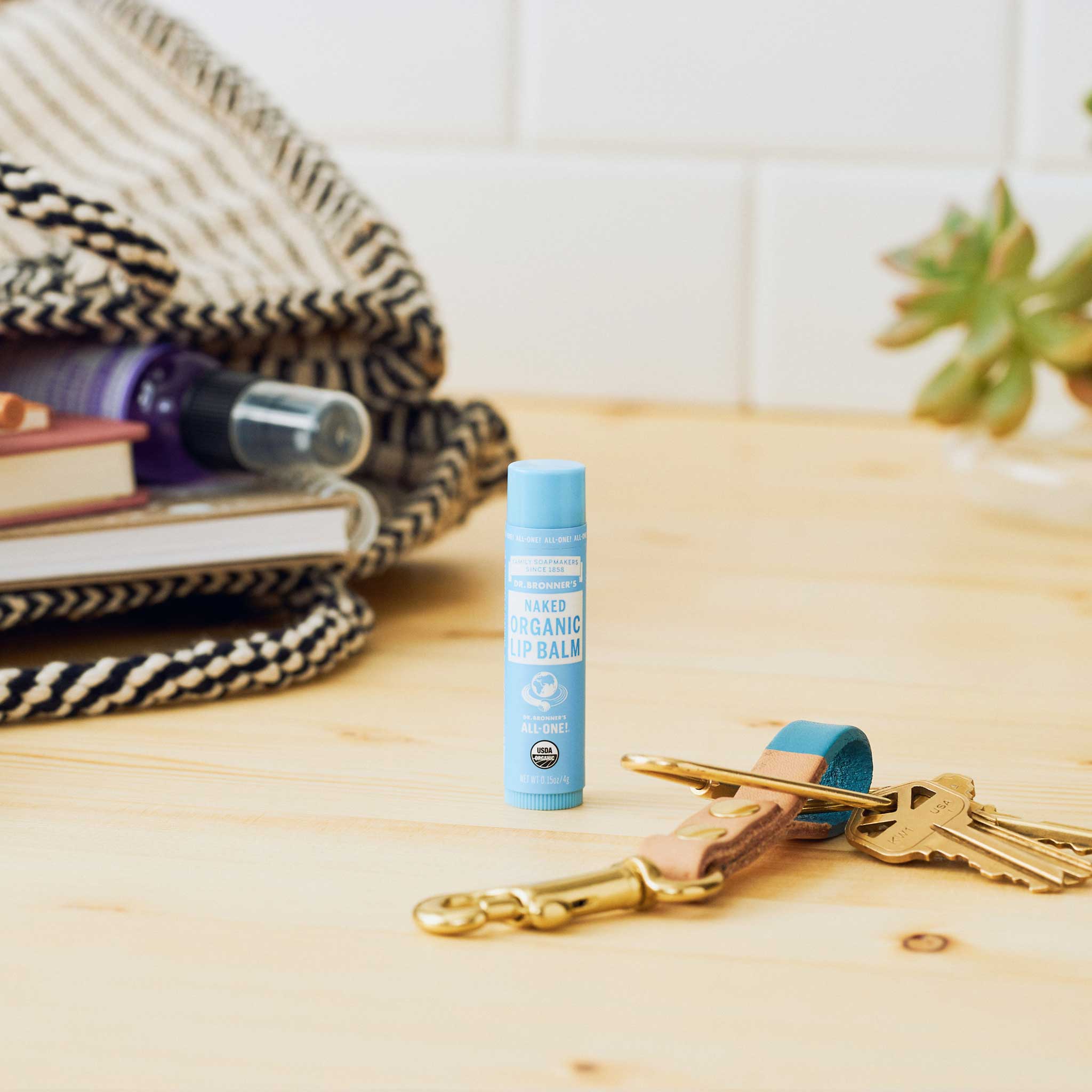 Dr. Bronner's Naked Organic Lip Balm in a lifestyle setting