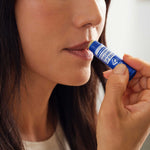 Person applying Dr. Bronner's Peppermint Organic Lip Balm