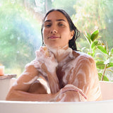 Person bathing with Dr. Bronner's Rose Pure-Castile Liquid Soap