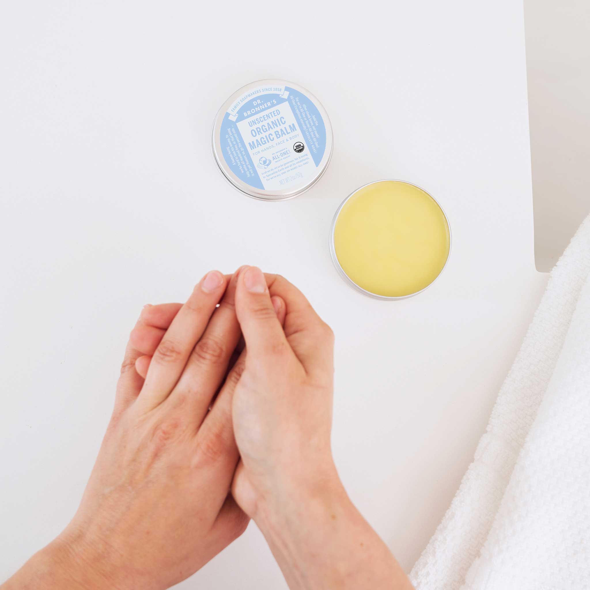 Person applying Dr. Bronner's Baby Unscented Organic Magic Balm