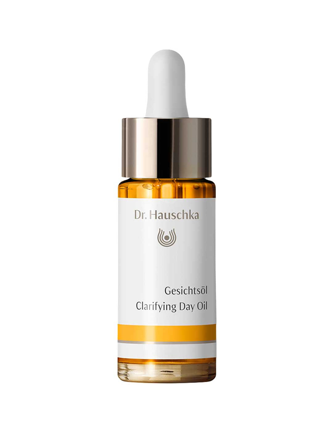Dr Hauschka Clarifying Day Oil in a clear bottle of golden oil with a white dropper bulb, reflective metal collar and white label with a yellow band.