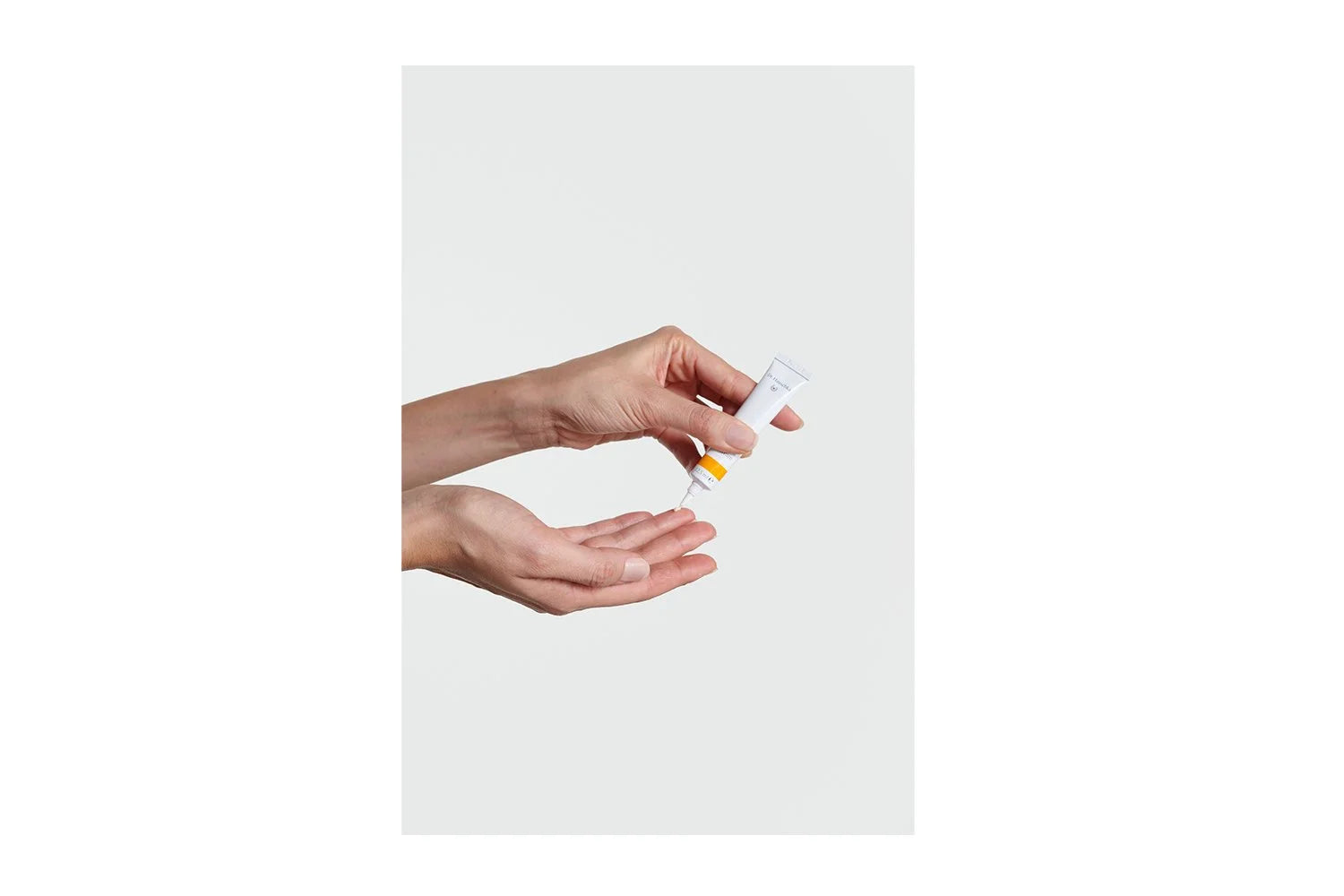 Hands holding Dr. Hauschka Daily Hydrating Eye Cream
