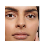 Close-up of a woman's brown eyes framed by dark, full, defined eyebrows, showing the finish of Dr Hauschka Eyebrow Definer.