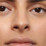 Close-up of a model's softly defined eyebrows showing the natural finish of Dr Hauschka Eyebrow Definer 1.05g.