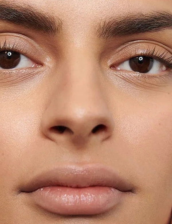 Close-up of a model's softly defined eyebrows showing the natural finish of Dr Hauschka Eyebrow Definer 1.05g.