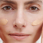 Model wearing two cheek swatches of Dr Hauschka Regenerating Day Cream Complexion Tinted 40ml before blending.