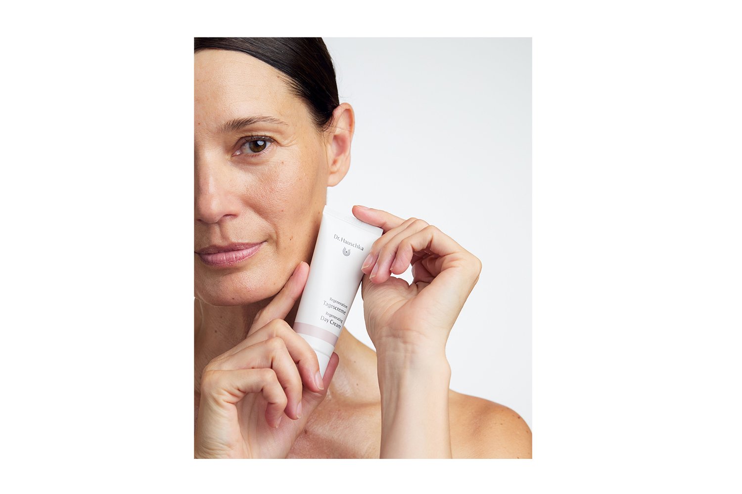 Model holding Dr. Hauschka Regenerating Day Cream