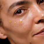 Close-up of Dr Hauschka Regenerating Eye Serum Intensive applied in small drops beneath a model's eye.