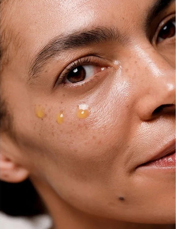 Close-up of Dr Hauschka Regenerating Eye Serum Intensive applied in small drops beneath a model's eye.