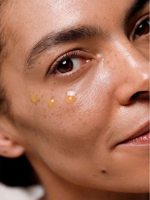 Close-up of Dr Hauschka Regenerating Eye Serum Intensive applied in small drops beneath a model's eye.