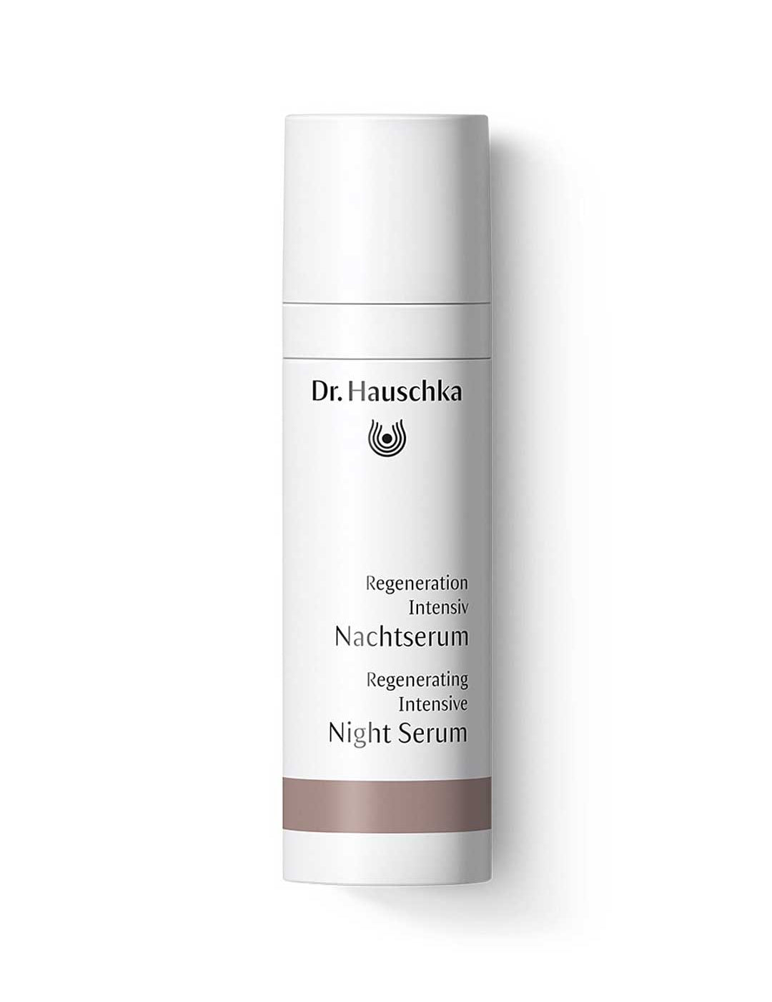 Dr Hauschka Regenerating Night Serum Intensive in a slim white cylindrical bottle with a tall white cap, dark lettering and a muted brown band near the base.