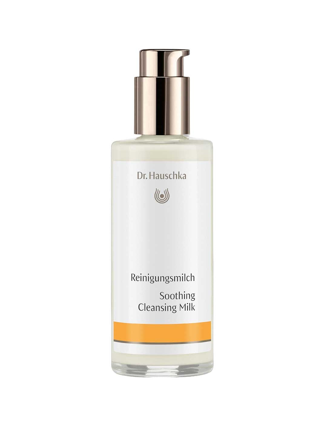 Dr Hauschka Soothing Cleansing Milk in a clear bottle containing ivory lotion, with a reflective metal pump and white label with a golden-yellow band.