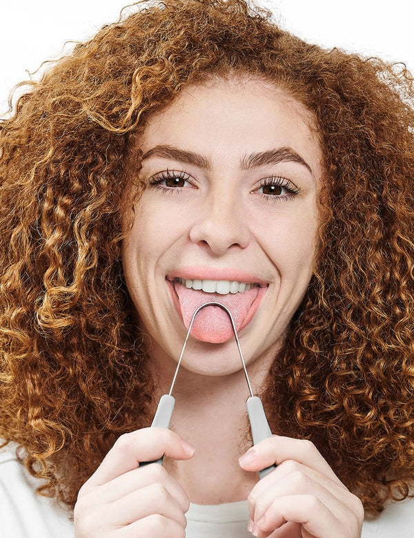 Person using Dr Tung's Copper Tongue Cleaner