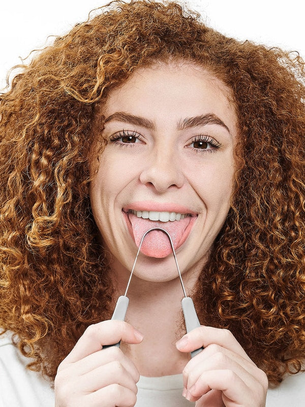 Person using Dr Tung's Copper Tongue Cleaner
