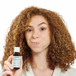 Person holding Dr Tung's Oil Pulling Concentrate