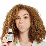 Person holding Dr Tung's Oil Pulling Concentrate
