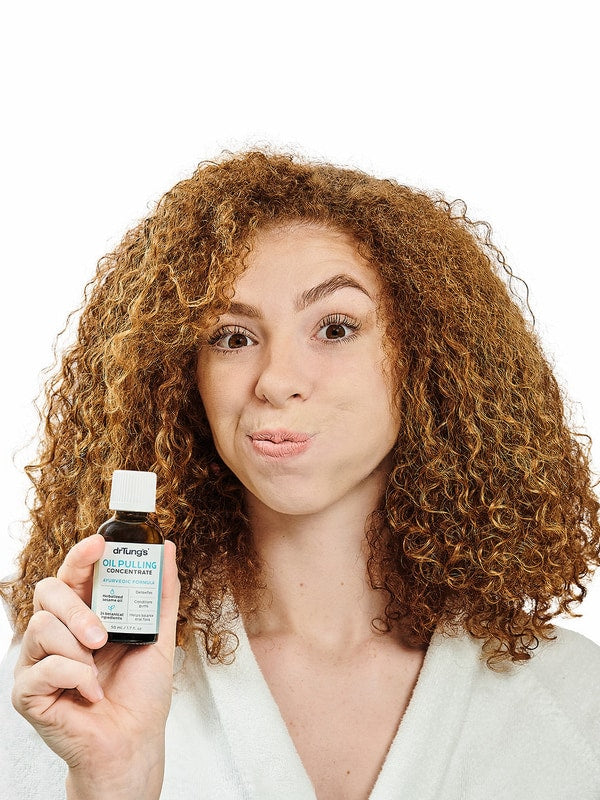 Person holding Dr Tung's Oil Pulling Concentrate