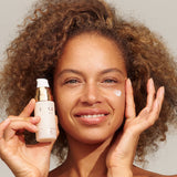 Model applying INIKA Organic Phytofuse Renew Serum to her face
